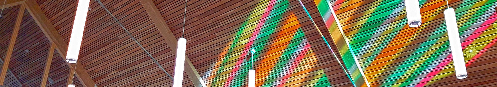 Light shining through stained glass window onto chapel ceiling